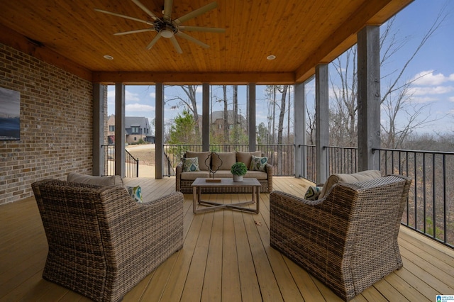 sunroom / solarium with wood ceiling and a ceiling fan