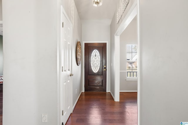 entrance foyer featuring baseboards and dark wood finished floors