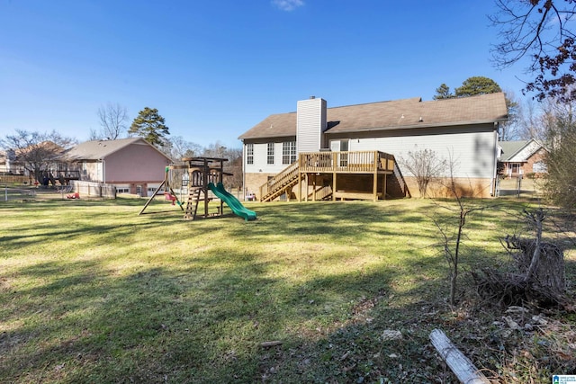 back of house with a chimney, stairway, fence, a yard, and a playground