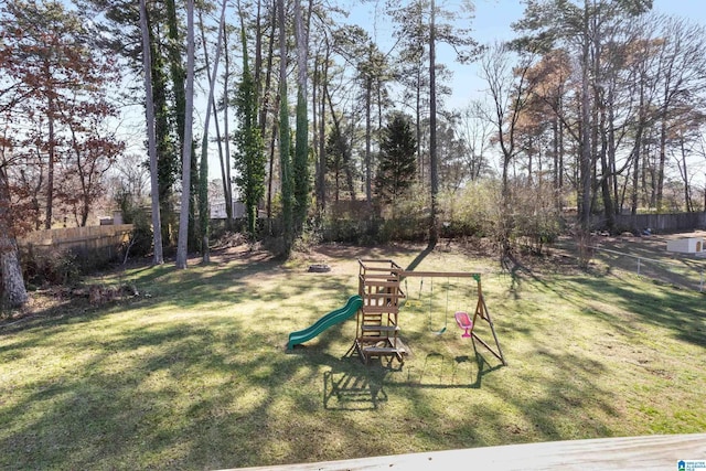 view of yard featuring fence and a playground