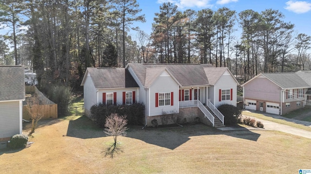 ranch-style home with a garage, covered porch, and a front lawn