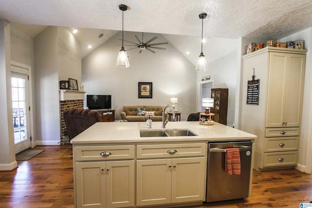 kitchen with a center island with sink, light countertops, stainless steel dishwasher, open floor plan, and a sink