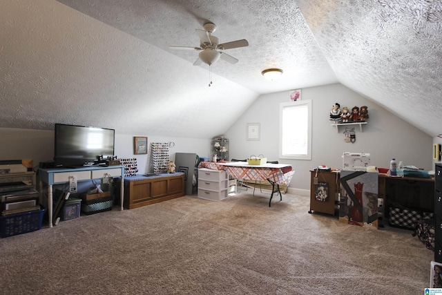 interior space with ceiling fan, carpet, vaulted ceiling, and a textured ceiling