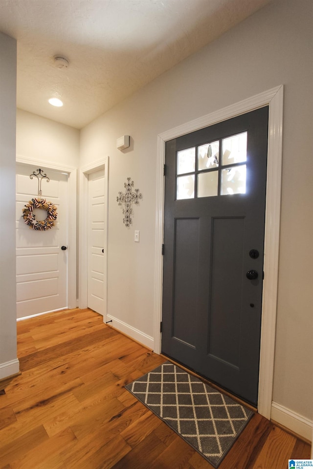 entrance foyer with wood finished floors and baseboards