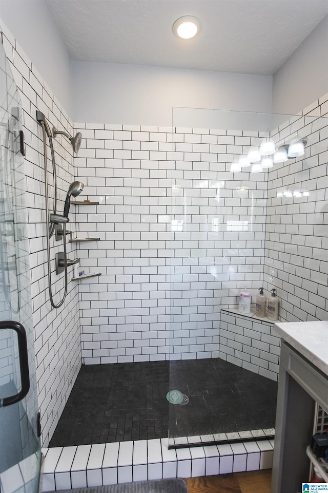 full bathroom featuring a stall shower and vanity