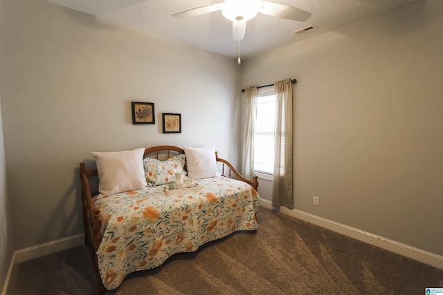 bedroom with ceiling fan, baseboards, visible vents, and dark colored carpet