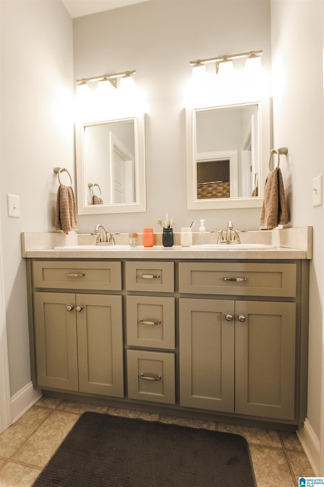 bathroom with tile patterned flooring, a sink, and double vanity