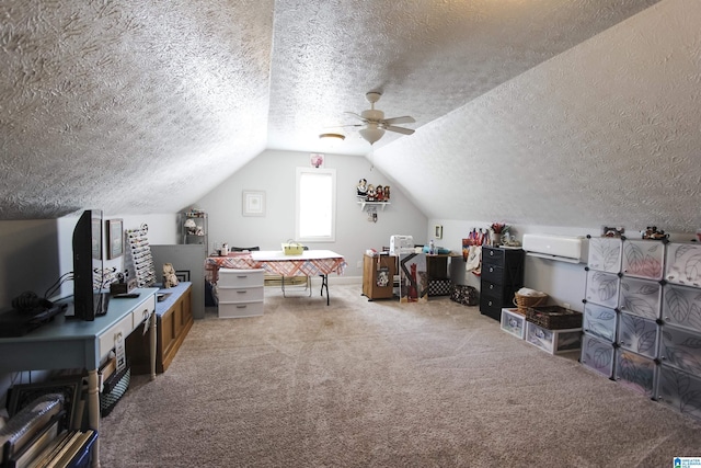 playroom featuring carpet flooring, vaulted ceiling, and a textured ceiling