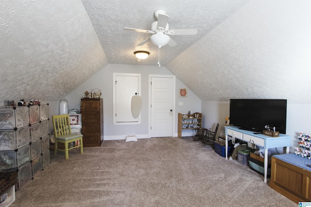 additional living space featuring lofted ceiling, a textured ceiling, carpet floors, a ceiling fan, and baseboards