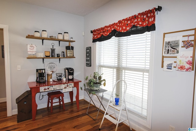 home office with dark wood-type flooring and baseboards