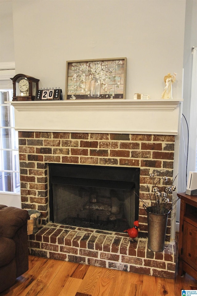 room details featuring a fireplace and wood finished floors