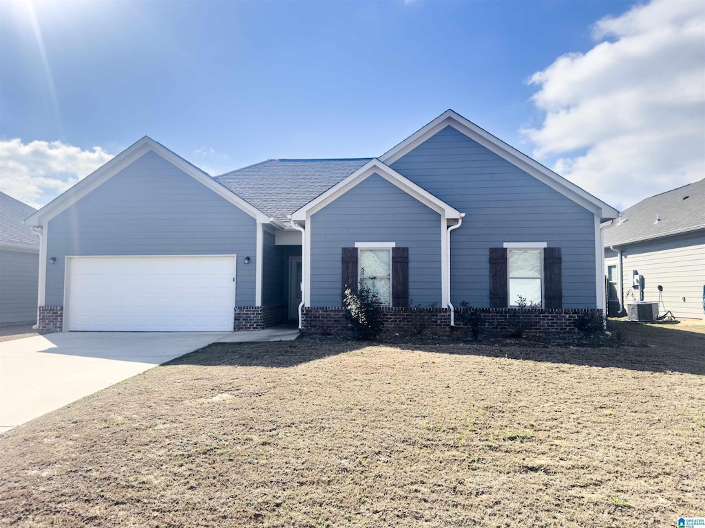 ranch-style house with an attached garage, driveway, and brick siding