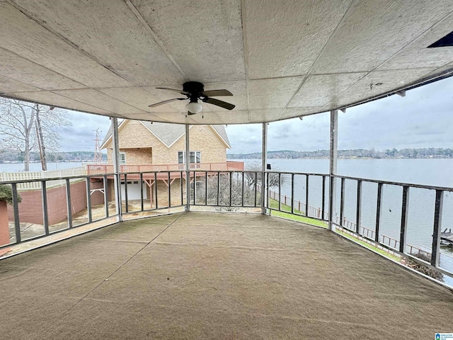 view of patio with a water view, a balcony, and ceiling fan