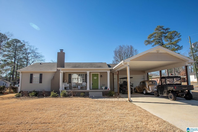 view of front facade with a chimney, covered porch, concrete driveway, an attached garage, and a front yard