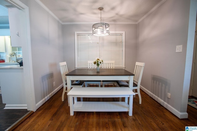 dining room with dark wood-type flooring, ornamental molding, and baseboards