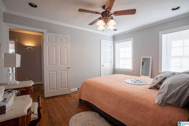 bedroom featuring dark wood-style floors, a ceiling fan, ornamental molding, and a textured ceiling