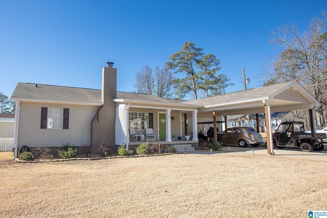 ranch-style house with driveway, a chimney, a porch, a carport, and a front yard