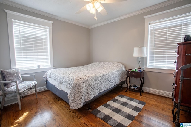 bedroom with baseboards, dark wood finished floors, and crown molding