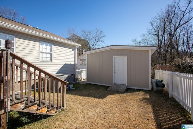 view of shed with a fenced backyard, central AC, and stairs