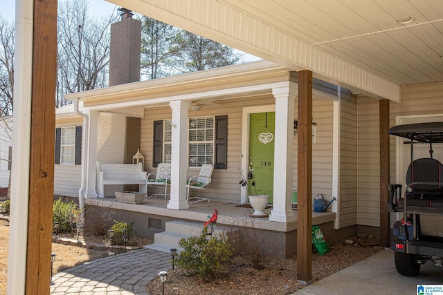 view of exterior entry featuring covered porch