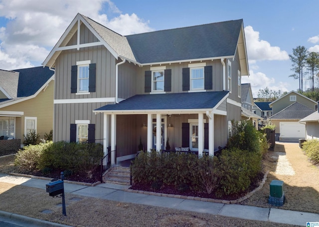 view of front of home featuring board and batten siding, a porch, and a shingled roof