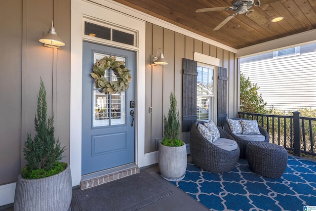 entrance to property featuring board and batten siding and a ceiling fan