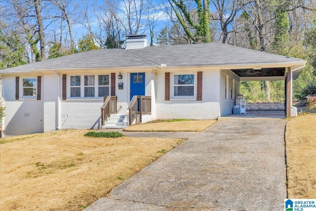 single story home featuring brick siding, driveway, a carport, a chimney, and a front yard