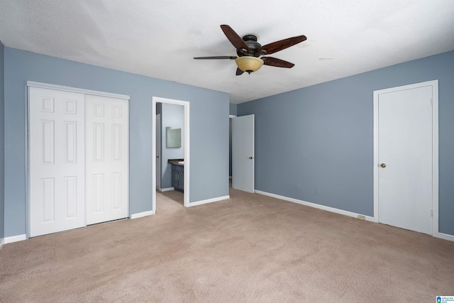 unfurnished bedroom featuring ensuite bath, baseboards, and light colored carpet