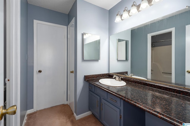 bathroom featuring vanity and baseboards