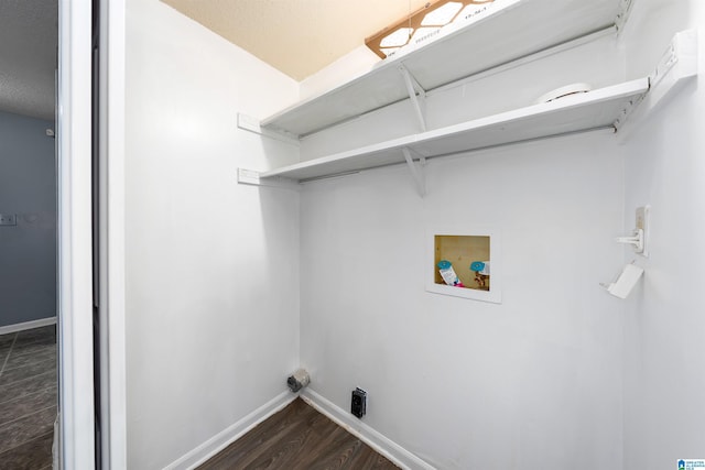 clothes washing area featuring hookup for a washing machine, laundry area, baseboards, and dark wood finished floors