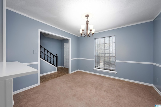 carpeted empty room featuring stairway, a textured ceiling, ornamental molding, and a notable chandelier