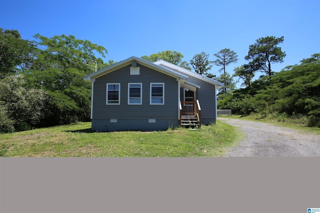 view of front of house with driveway, a front lawn, and crawl space