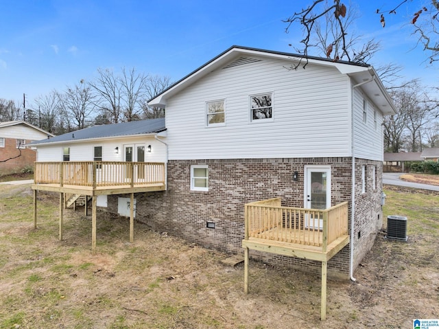 rear view of house featuring central AC, brick siding, crawl space, and a wooden deck