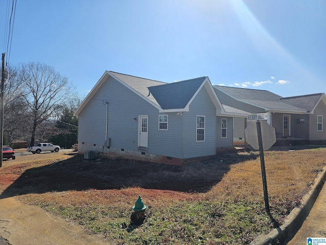 view of side of home featuring crawl space and central AC