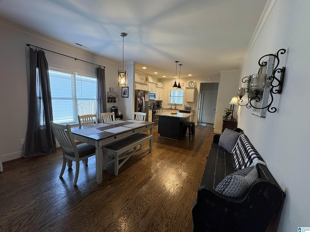 dining area with visible vents, ornamental molding, and dark wood-style flooring