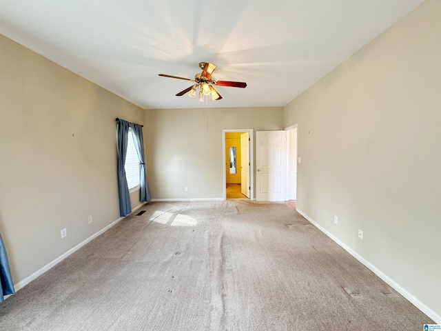 unfurnished room with light carpet, ceiling fan, visible vents, and baseboards