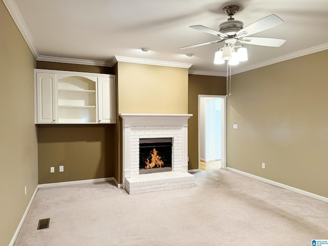 unfurnished living room with light carpet, a fireplace, and crown molding