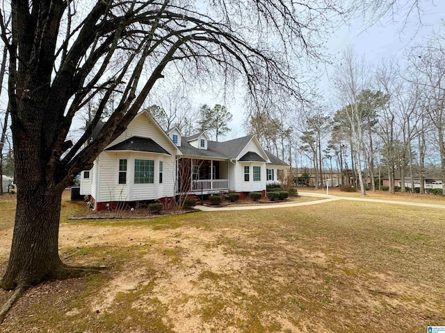 ranch-style house featuring a porch and a front yard