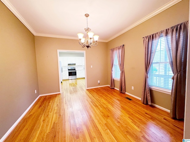 unfurnished dining area with a notable chandelier, ornamental molding, visible vents, and light wood-style floors