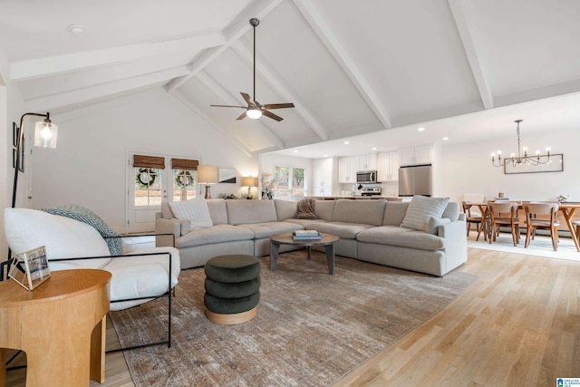 living room featuring high vaulted ceiling, beam ceiling, and light wood finished floors