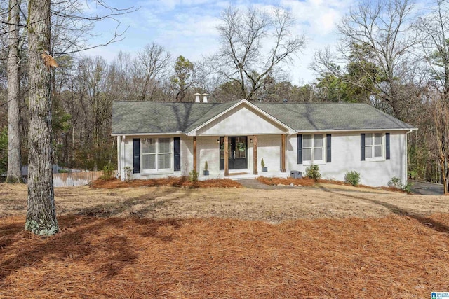 ranch-style home featuring brick siding and fence