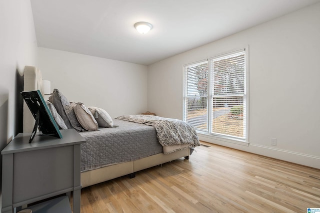 bedroom featuring light wood-type flooring and baseboards