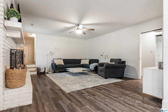 living area with dark wood-style floors, ceiling fan, visible vents, and crown molding