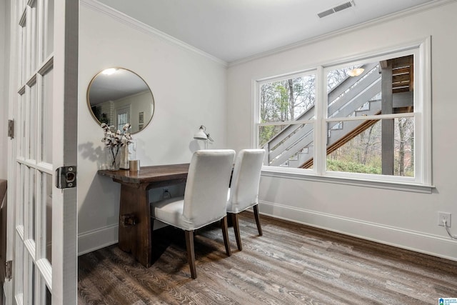 office area featuring baseboards, visible vents, wood finished floors, and ornamental molding