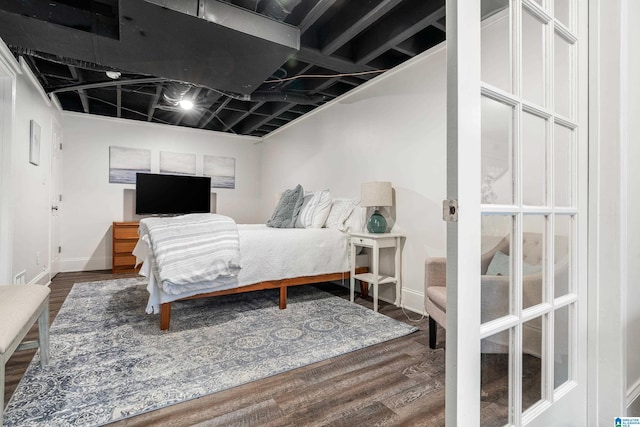 bedroom with baseboards and wood finished floors