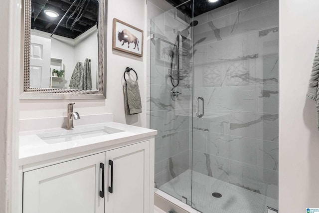 full bath with a stall shower and vanity