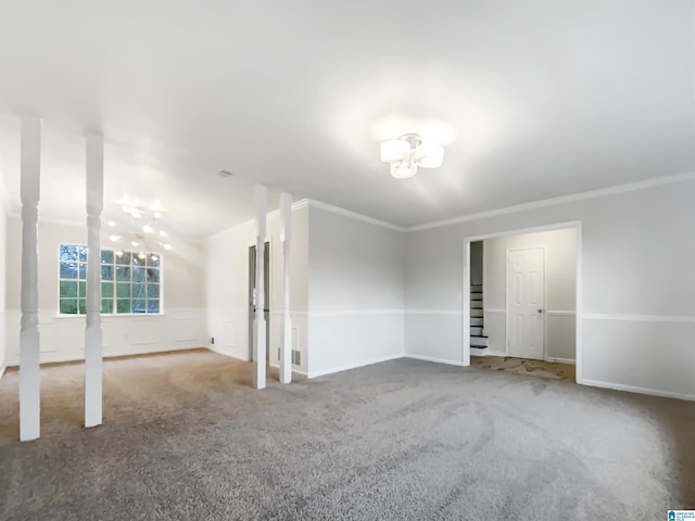 spare room with a chandelier, carpet floors, and crown molding