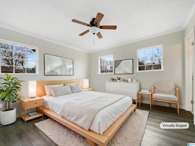 bedroom with dark wood-style floors, ornamental molding, baseboards, and ceiling fan