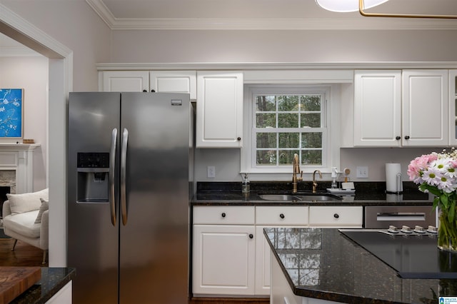 kitchen with crown molding, white cabinetry, a sink, and stainless steel refrigerator with ice dispenser