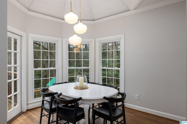 dining area featuring ornamental molding, a healthy amount of sunlight, wood finished floors, and baseboards